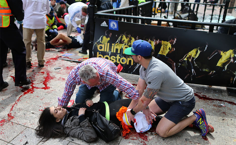 An injured woman is tended to at the finish line of the Boston Marathon, in Boston, Monday, April 15, 2013. AP Photo/The Boston Globe, John Tlumacki An injured woman is tended to at the finish line of the Boston Marathon, in Boston, Monday, April 15, 2013. AP Photo/The Boston Globe, John Tlumacki