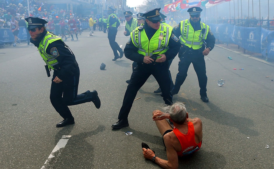 Bill Iffrig, 78, lies on the ground as police officers react to a second explosion at the finish line of the Boston Marathon in Boston, Monday, April 15, 2013. Iffrig, of Lake Stevens, Wash., was running his third Boston Marathon and near the finish line when he was knocked down by one of two bomb blasts. AP Photo/The Boston Globe, John Tlumacki Bill Iffrig, 78, lies on the ground as police officers react to a second explosion at the finish line of the Boston Marathon in Boston, Monday, April 15, 2013. Iffrig, of Lake Stevens, Wash., was running his third Boston Marathon and near the finish line when he was knocked down by one of two bomb blasts. AP Photo/The Boston Globe, John Tlumacki