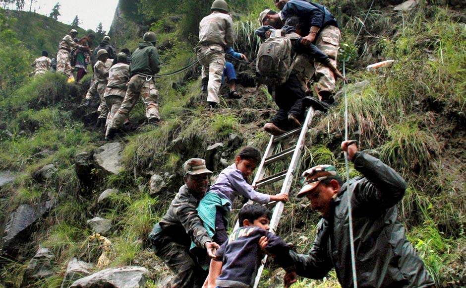 Chamoli: Army personnel rescue stranded pilgrims to a safe place in flood-hit Govind Ghat in Chamoli, Uttarakhand. PTI Chamoli: Army personnel rescue stranded pilgrims to a safe place in flood-hit Govind Ghat in Chamoli, Uttarakhand. PTI