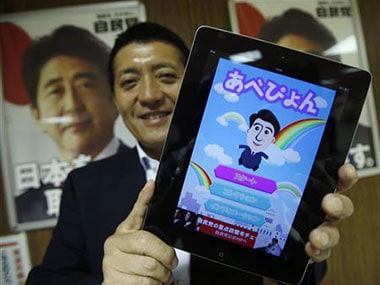 Japan PM Abe hops and flips new mobile game to woo young voters