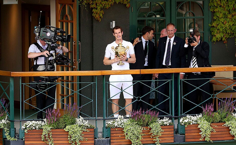 Andy Murray stands on the balcony of Centre Court with the trophy after winning the Men's singles title at Wimbledon. Dominic Lipinski/Associated Press Andy Murray stands on the balcony of Centre Court with the trophy after winning the Men's singles title at Wimbledon. Dominic Lipinski/Associated Press