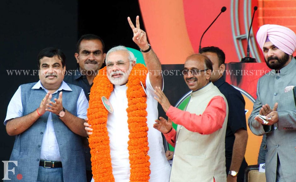 Modi getting garlanded by the Delhi unit of BJP before his speech. BJP leader Nitin Gadkari (L) and Vijay Goel (R) are also seen. Naresh Sharma/Firstpost. Modi getting garlanded by the Delhi unit of BJP before his speech. BJP leader Nitin Gadkari (L) and Vijay Goel (R) are also seen. Naresh Sharma/Firstpost.