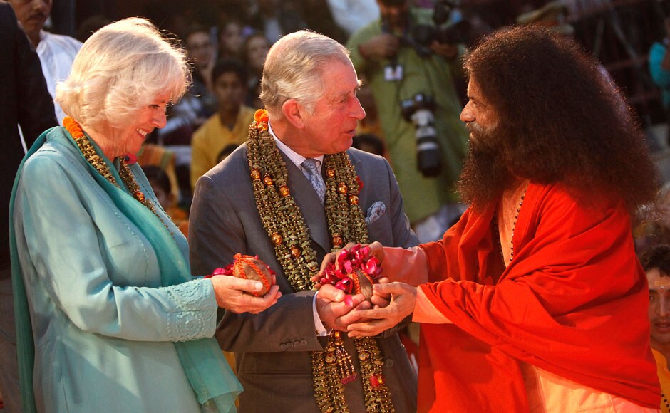 Britain's Prince Charles (C) and his wife Camilla (L), Duchess of Cornwall, perform a ritual as part of an aarti ceremony at the Parmarth Miketan Temple on the banks of the Ganga, November 6, 2013. REUTERS Britain's Prince Charles (C) and his wife Camilla (L), Duchess of Cornwall, perform a ritual as part of an aarti ceremony at the Parmarth Miketan Temple on the banks of the Ganga, November 6, 2013. REUTERS