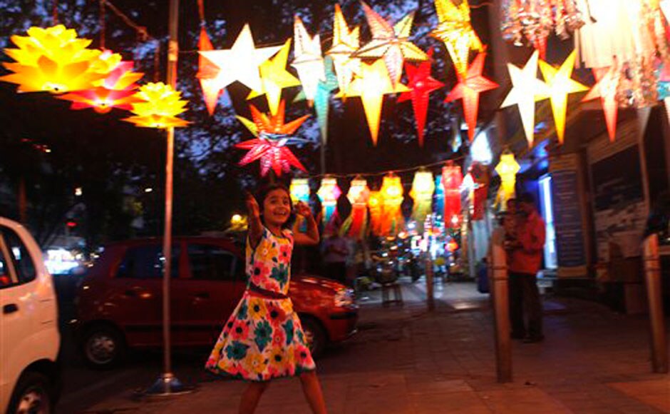 A child runs past Diwali lanterns in Mumbai: AP A child runs past Diwali lanterns in Mumbai: AP