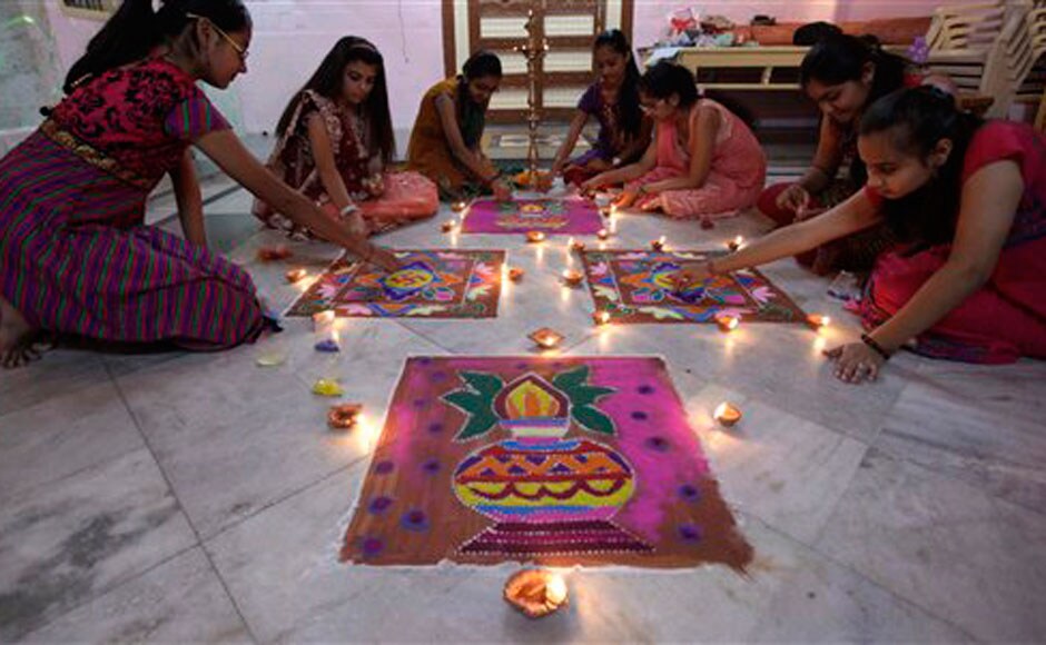 Ahmedabad: Girls make rangoli for diwali: AP Ahmedabad: Girls make rangoli for diwali: AP