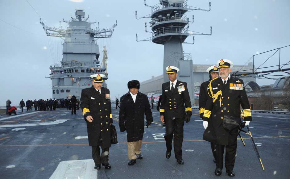 Defence Minister AK Antony walking on the flight deck of INS Vikramaditya, at Sevmash Shipyard in Russia on 16 November 2013. The Chief of Naval Staff, Admiral DK Joshi is also seen. Image courtesy PIB Defence Minister AK Antony walking on the flight deck of INS Vikramaditya, at Sevmash Shipyard in Russia on 16 November 2013. The Chief of Naval Staff, Admiral DK Joshi is also seen. Image courtesy PIB