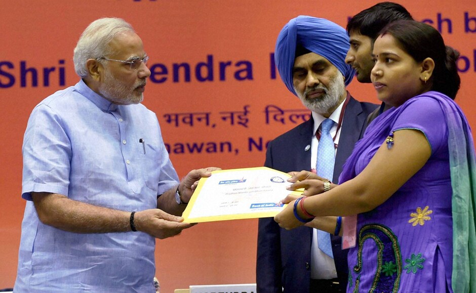 New Delhi: Prime Minister Narendra Modi felicitating a beneficiary couple at the launch of the Pradhan Mantri Jan Dhan Yojana in New Delhi on Thursday. PTI New Delhi: Prime Minister Narendra Modi felicitating a beneficiary couple at the launch of the Pradhan Mantri Jan Dhan Yojana in New Delhi on Thursday. PTI