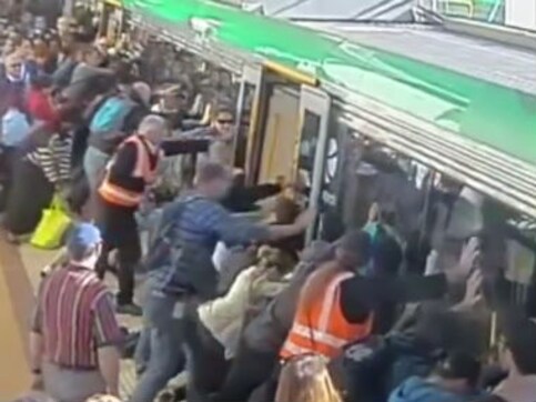 In Perth, Aussie commuters push train car to help free trapped man In Perth, Aussie commuters push train car to help free trapped man