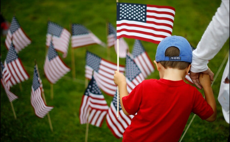 Three-year-old Charlie Lewis holds his mother Lauren's hand near some of the 3,000 flags placed in memory of the lives lost in the September 11, 2001 attacks at a park in Winnetka, Illinois September 10, 2014. Reuters Three-year-old Charlie Lewis holds his mother Lauren's hand near some of the 3,000 flags placed in memory of the lives lost in the September 11, 2001 attacks at a park in Winnetka, Illinois September 10, 2014. Reuters