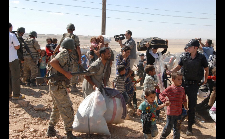 Syrian Kurds cross the border fence into Turkey near Suruc. More than 1,30,000 Syrian Kurds fleeing an advance by Islamic State militants have crossed into Turkey in the past three days and the authorities are preparing for more, Turkish Deputy Prime Minister Numan Kurtulmus said on Monday. Reuters Syrian Kurds cross the border fence into Turkey near Suruc. More than 1,30,000 Syrian Kurds fleeing an advance by Islamic State militants have crossed into Turkey in the past three days and the authorities are preparing for more, Turkish Deputy Prime Minister Numan Kurtulmus said on Monday. Reuters