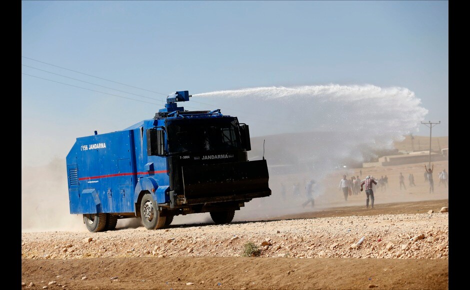 Turkish security forces dose with water protestors during a pro-Kurdish protest near the southeastern town of Suruc in Sanliurfa province on 22 September. Reuters Turkish security forces dose with water protestors during a pro-Kurdish protest near the southeastern town of Suruc in Sanliurfa province on 22 September. Reuters