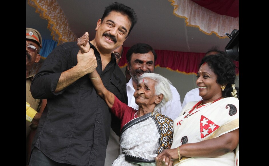 Kamal Haasan poses for photos with an elderly woman, who is probably a fan. Firstpost Kamal Haasan poses for photos with an elderly woman, who is probably a fan. Firstpost