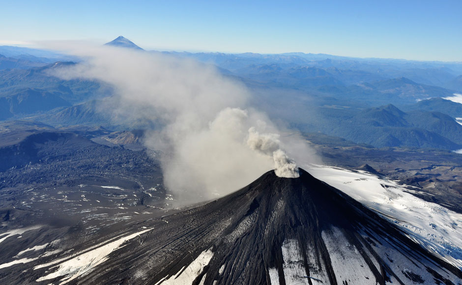 An aerial view shows smoke and ash rising from Villarrica Volcano. Villarrica Volcano which erupted earlier this month before settling down, has entered a more active phase again, expelling gas and ash into the atmosphere, Chilean authorities. (Reuters image) An aerial view shows smoke and ash rising from Villarrica Volcano. Villarrica Volcano which erupted earlier this month before settling down, has entered a more active phase again, expelling gas and ash into the atmosphere, Chilean authorities. (Reuters image)