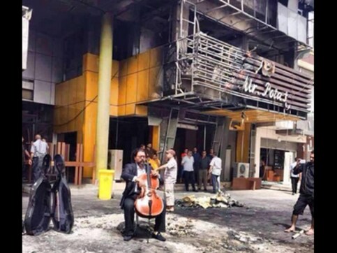 A man plays his cello at destruction site just hours after bombs rattles Baghdad A man plays his cello at destruction site just hours after bombs rattles Baghdad