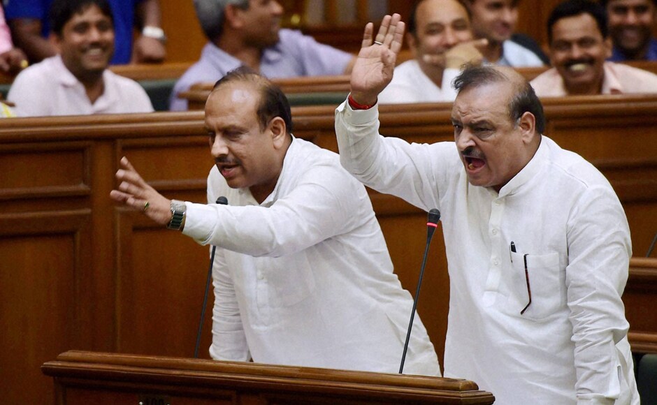 BJP MLAs Vijender Gupta and OP Sharma protest in the Delhi Assembly on the first day of its monsoon session in New Delhi on Tuesday. PTI BJP MLAs Vijender Gupta and OP Sharma protest in the Delhi Assembly on the first day of its monsoon session in New Delhi on Tuesday. PTI