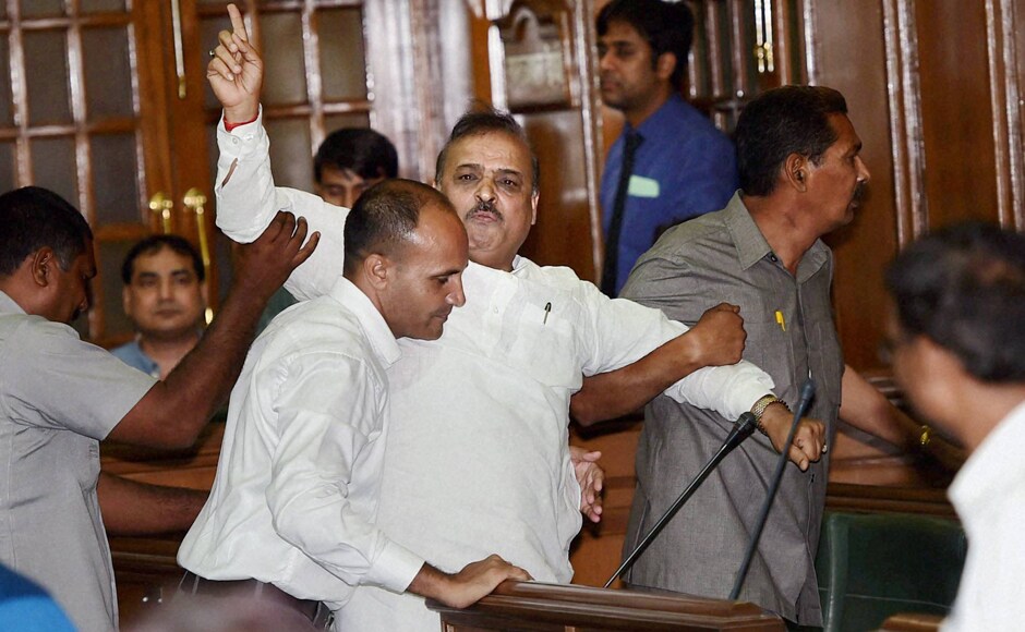 BJP MLA OP Sharma is marshalled out of Delhi Assembly after his protest on the first day of the monsoon session in New Delhi on Tuesday. PTI BJP MLA OP Sharma is marshalled out of Delhi Assembly after his protest on the first day of the monsoon session in New Delhi on Tuesday. PTI