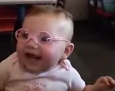 20-20 vision! Baby can't stop smiling after putting on new glasses