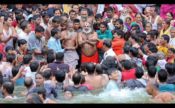 Colourful devotees take a dip in Godavari during ongoing Kumbh Mela Colourful devotees take a dip in Godavari during ongoing Kumbh Mela
