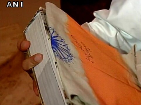 Modi signs the Tricolour: Has the PM run afoul of the Flag Code of India? Modi signs the Tricolour: Has the PM run afoul of the Flag Code of India?