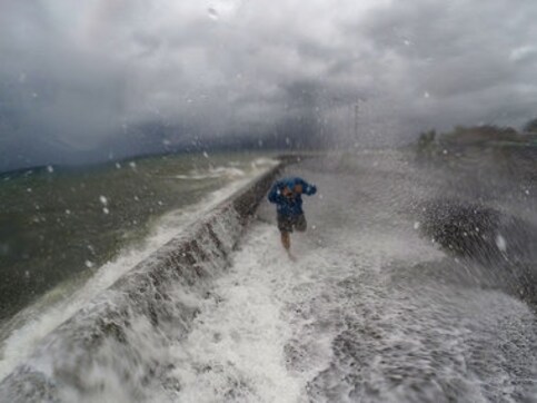 Millions without power, three dead as typhoon hits Philippines Millions without power, three dead as typhoon hits Philippines