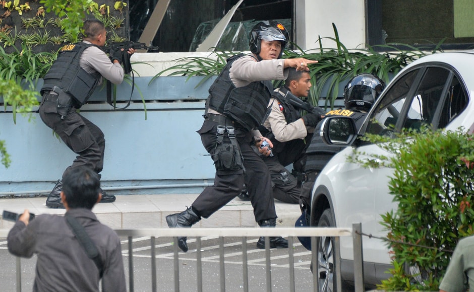 Indonesian police take position and aim their weapons as they pursue suspects outside a cafe after a series of blasts hit the Indonesian capital. Indonesia has been a victim of several bombing attacks in the past, claimed by Islamic militant groups. AFP Indonesian police take position and aim their weapons as they pursue suspects outside a cafe after a series of blasts hit the Indonesian capital. Indonesia has been a victim of several bombing attacks in the past, claimed by Islamic militant groups. AFP