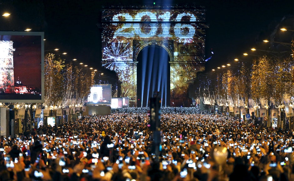 Bonne année: Revellers gather near the Arc de Triomphe in Paris, France for New Year celebrations. Reuters Bonne année: Revellers gather near the Arc de Triomphe in Paris, France for New Year celebrations. Reuters