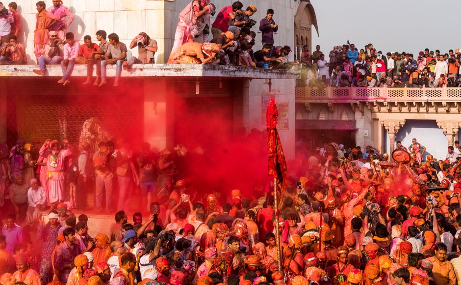 As the villagers of Nandgaon were busy throwing colours on each other, some others took the opportunity to perch on top of building to take photos. AFP As the villagers of Nandgaon were busy throwing colours on each other, some others took the opportunity to perch on top of building to take photos. AFP
