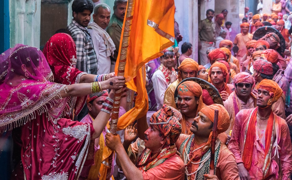 Indian women from the north Indian village Nandgaon use large sticks to hit men holding shields as they participate in the celebrations of Lathmaar Holi. AFP Indian women from the north Indian village Nandgaon use large sticks to hit men holding shields as they participate in the celebrations of Lathmaar Holi. AFP