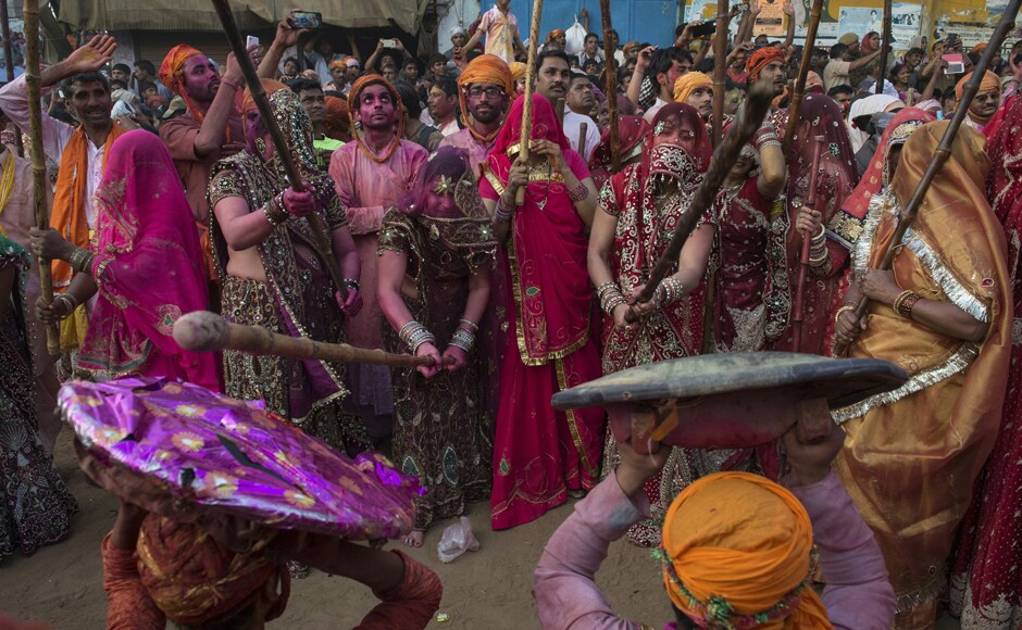 Villagers in Uttar Pradesh's Nandgaon celebrate the Lathmar Holi festival. AFP Villagers in Uttar Pradesh's Nandgaon celebrate the Lathmar Holi festival. AFP