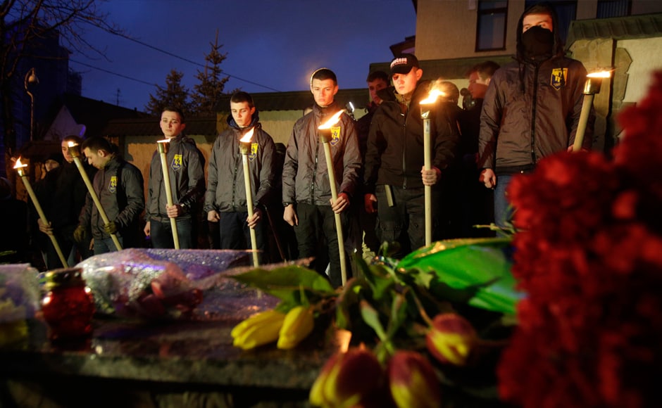 Servicemen of Azov, Ukrainian volonteers battalion, hold torches in front of floral tributes during a ceremony in front of the Belgian embassy in Kiev on 22 March, in tribute to the victims of Brussels. AFP Servicemen of Azov, Ukrainian volonteers battalion, hold torches in front of floral tributes during a ceremony in front of the Belgian embassy in Kiev on 22 March, in tribute to the victims of Brussels. AFP