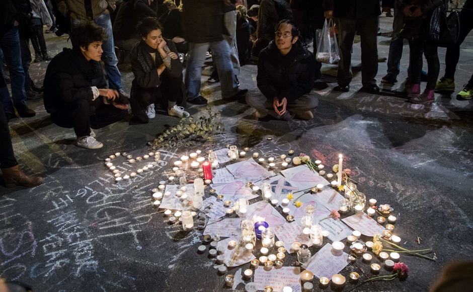 People gather around floral tributes, drawings, candles and notes in front of the Bourse of Brussels on 22 March in tribute to the victims of Brussels following triple bomb attacks in the Belgian capital. AFP People gather around floral tributes, drawings, candles and notes in front of the Bourse of Brussels on 22 March in tribute to the victims of Brussels following triple bomb attacks in the Belgian capital. AFP