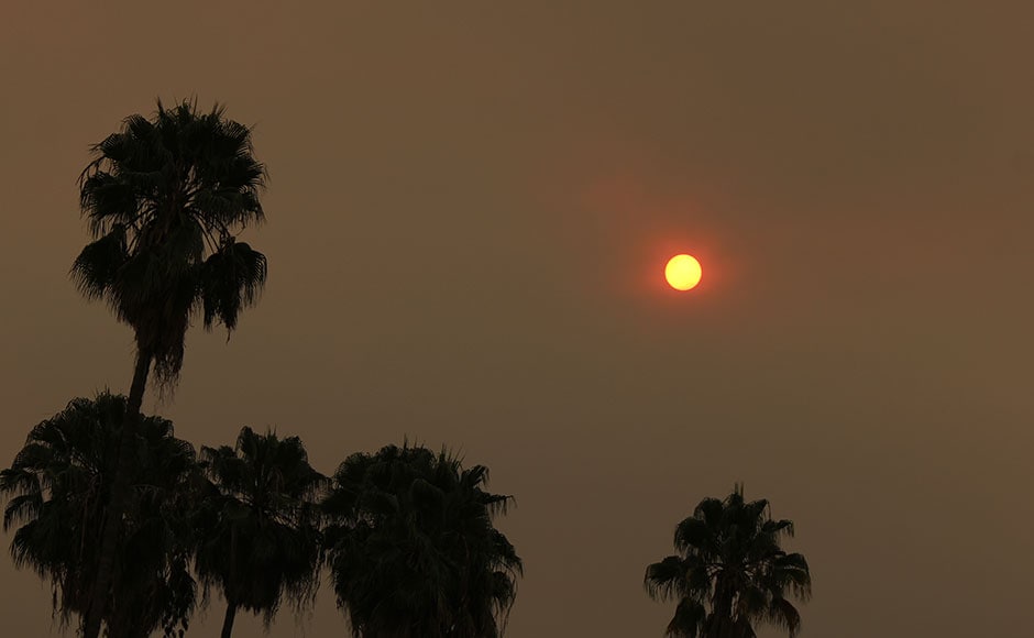 The morning sun over Pasadena, Calif., is reduced to an orange disk by smoke from a wildfire burning north of Los Angeles. AP The morning sun over Pasadena, Calif., is reduced to an orange disk by smoke from a wildfire burning north of Los Angeles. AP