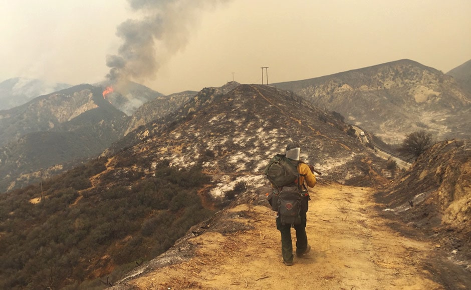 USDA Forest Service firefighter Simeon Hagens, with Angeles National Forest, packs out off of Little Tujunga Canyon Road in Santa Clarita. The fire in northern Los Angeles County darkened skies with smoke that spread across the city and suburbs, reducing the sun to an orange disk at times. The South Coast Air Quality Management District warned that at times air would reach unhealthy levels. The fire erupted Friday afternoon in the Sand Canyon area near State Route 14 as the region was gripped by high heat and very low humidity.AP USDA Forest Service firefighter Simeon Hagens, with Angeles National Forest, packs out off of Little Tujunga Canyon Road in Santa Clarita. The fire in northern Los Angeles County darkened skies with smoke that spread across the city and suburbs, reducing the sun to an orange disk at times. The South Coast Air Quality Management District warned that at times air would reach unhealthy levels. The fire erupted Friday afternoon in the Sand Canyon area near State Route 14 as the region was gripped by high heat and very low humidity.AP