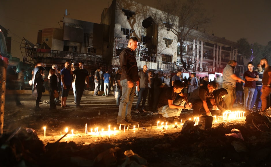 People light candles at the scene of the attack on Sunday night. Karrada was busy at the time as Iraqis eat out and shop late during the Muslim fasting month of Ramzan, which ends next week with the Eid al-Fitr festival. Photo Courtesy: AP People light candles at the scene of the attack on Sunday night. Karrada was busy at the time as Iraqis eat out and shop late during the Muslim fasting month of Ramzan, which ends next week with the Eid al-Fitr festival. Photo Courtesy: AP