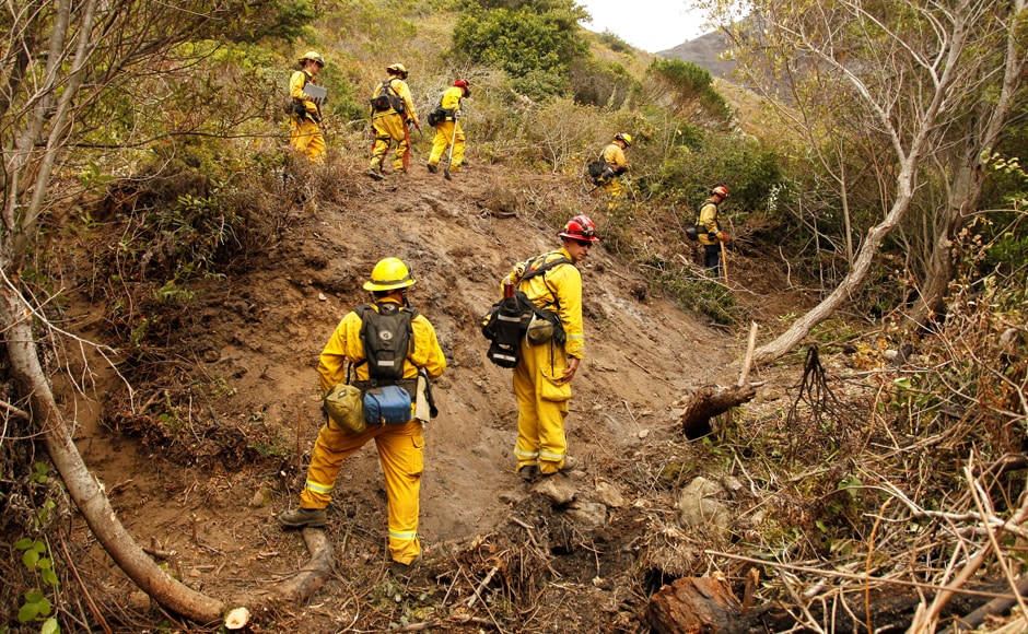 Captain Ben Cowles (C) and other firefighters from El Dorado Hills create fire breaks in rugged terrain at Garrapata State Park during the Soberanes Fire. More than 5,000 firefighters are battling the wildfire that killed a bulldozer operator working the fire line. The blaze, about the size of San Francisco, has also scared away tourists. Reuters Captain Ben Cowles (C) and other firefighters from El Dorado Hills create fire breaks in rugged terrain at Garrapata State Park during the Soberanes Fire. More than 5,000 firefighters are battling the wildfire that killed a bulldozer operator working the fire line. The blaze, about the size of San Francisco, has also scared away tourists. Reuters