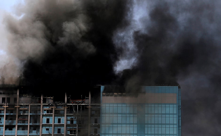 Civil defence personnel helped construction workers in the building, as well as guests and staff at an adjacent luxury hotel, evacuate with no serious injuries. Reuters Civil defence personnel helped construction workers in the building, as well as guests and staff at an adjacent luxury hotel, evacuate with no serious injuries. Reuters