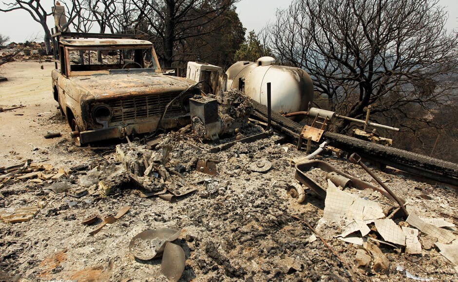 A burned out vehicle and a wagon are seen at the site of a destroyed house after the Soberanes Fire burned through the Palo Colorado area. The wildfire has destroyed 57 homes and 11 outbuildings and is threatening 2,000 more structures. It was 18 percent contained Sunday morning. Reuters A burned out vehicle and a wagon are seen at the site of a destroyed house after the Soberanes Fire burned through the Palo Colorado area. The wildfire has destroyed 57 homes and 11 outbuildings and is threatening 2,000 more structures. It was 18 percent contained Sunday morning. Reuters