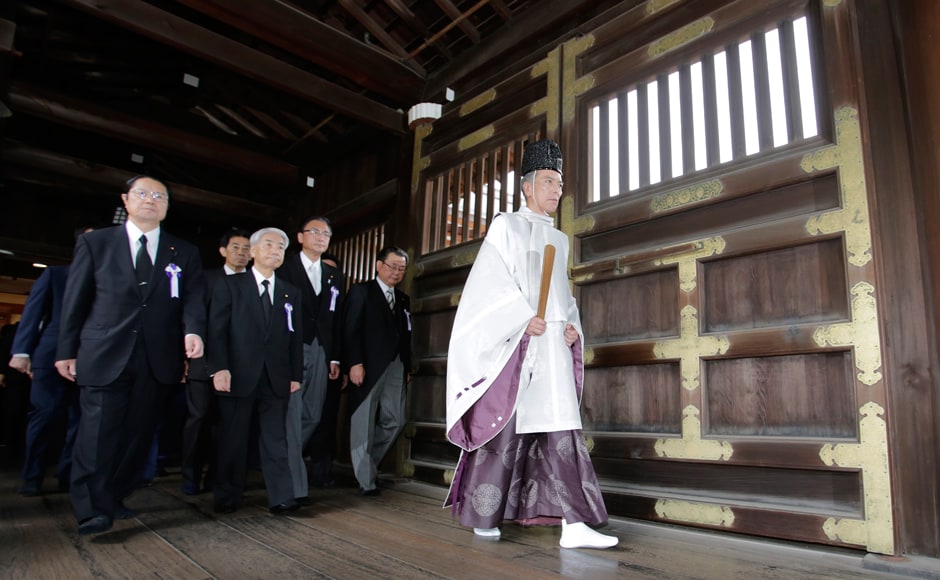 Japanese lawmakers visited the Yasukuni Shrine to offer prayers to the war dead. The Shrine honours millions of mostly Japanese war dead, as well as senior military and political figures convicted of war crimes after the war. Photo: AP Japanese lawmakers visited the Yasukuni Shrine to offer prayers to the war dead. The Shrine honours millions of mostly Japanese war dead, as well as senior military and political figures convicted of war crimes after the war. Photo: AP