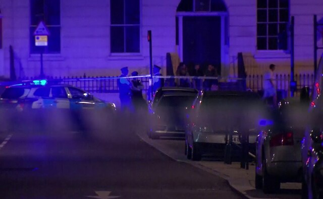 Police officers stand behind cordon tape after a knife attack. The police urged the public to remain calm, alert and vigilant. AP Police officers stand behind cordon tape after a knife attack. The police urged the public to remain calm, alert and vigilant. AP