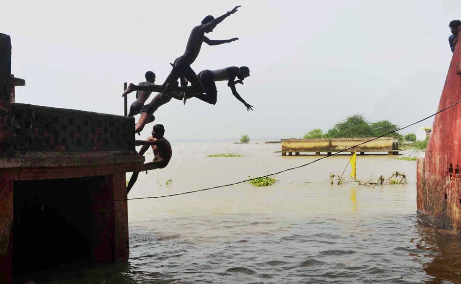Boys jump in flood water at Daraganj area in Allahabad while in the last 24-hours, the river Ganga receded by about 40 cm while Yamuna's water levels decreased by about 30 cm. Boys jump in flood water at Daraganj area in Allahabad while in the last 24-hours, the river Ganga receded by about 40 cm while Yamuna's water levels decreased by about 30 cm.