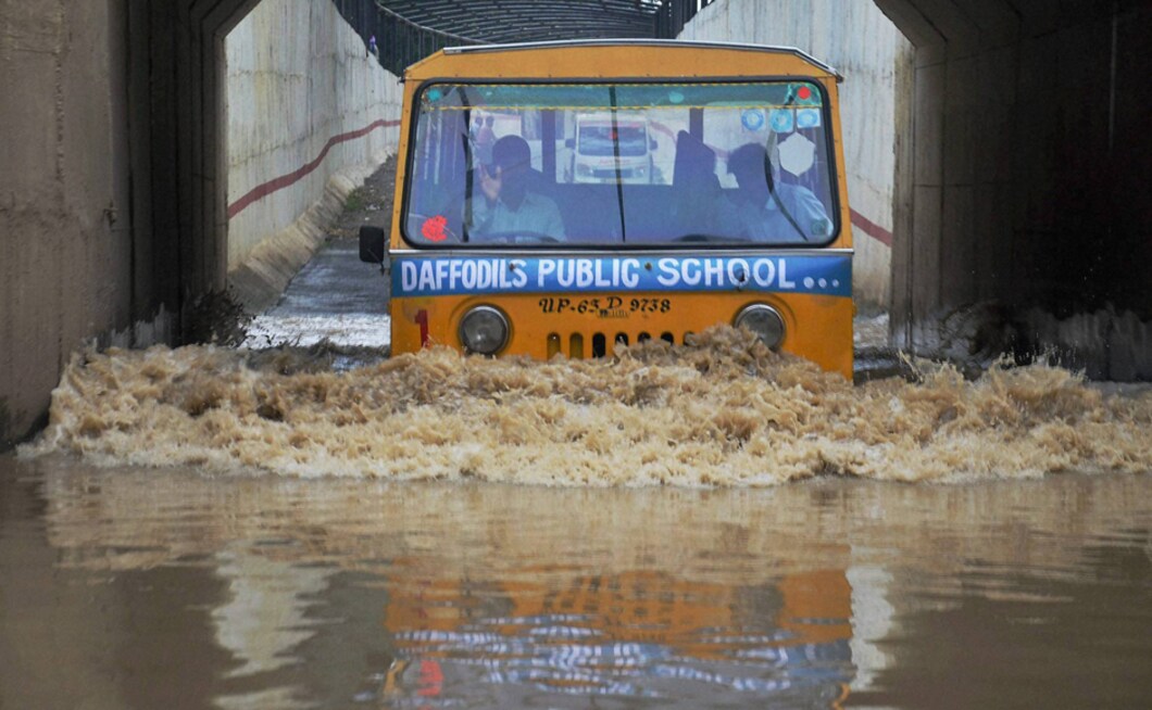 In Mirzapur, Uttar Pradesh, a school van passes through a flooded road after heavy rains in the city on Tuesday. The Met department has forecast rain or thundershower at most places in the state and heavy rain in isolated places in the next week. PTI In Mirzapur, Uttar Pradesh, a school van passes through a flooded road after heavy rains in the city on Tuesday. The Met department has forecast rain or thundershower at most places in the state and heavy rain in isolated places in the next week. PTI