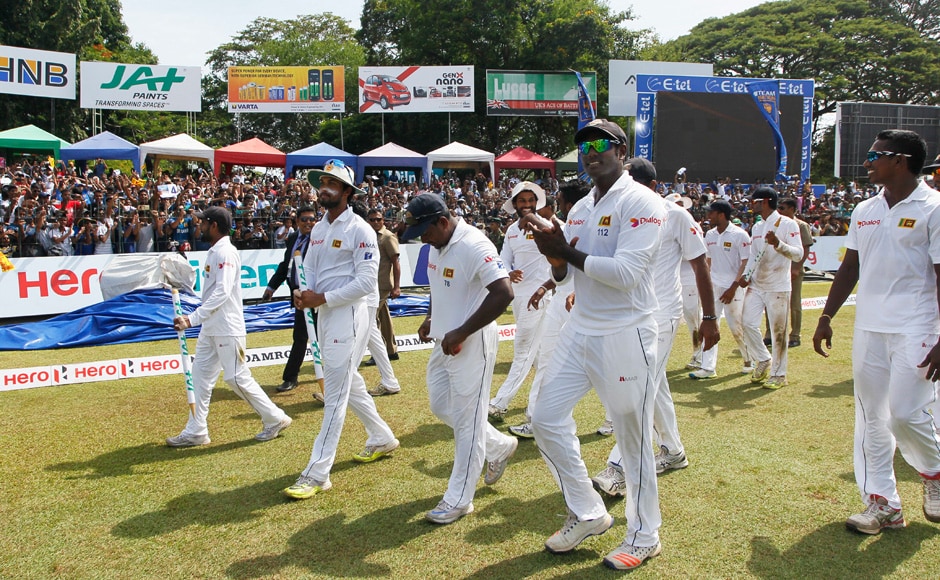 Sri Lankan cricketers walk around the stadium to the cheering crowds to celebrate their historic win over Australia. (Photo courtesy: AP) Sri Lankan cricketers walk around the stadium to the cheering crowds to celebrate their historic win over Australia. (Photo courtesy: AP)
