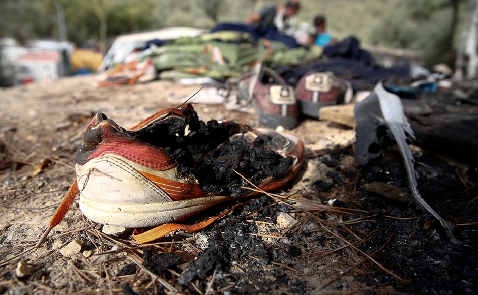 A burned shoe is seen on the ground. The United Nations refugee agency, UNHCR, linked the fire to poor living conditions and a sense of insecurity among many of the residents. Reuters A burned shoe is seen on the ground. The United Nations refugee agency, UNHCR, linked the fire to poor living conditions and a sense of insecurity among many of the residents. Reuters