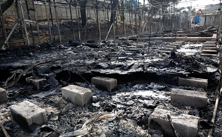 The remains of a burned tent at the Moria migrant camp. Thousands of people fled the camp on the Greek island of Lesbos after fire swept through tents and cabins during violence among residents. Reuters The remains of a burned tent at the Moria migrant camp. Thousands of people fled the camp on the Greek island of Lesbos after fire swept through tents and cabins during violence among residents. Reuters
