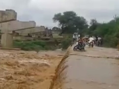 Watch: Telangana biker swept off road by a raging Musi river, tide steers him to safety Watch: Telangana biker swept off road by a raging Musi river, tide steers him to safety