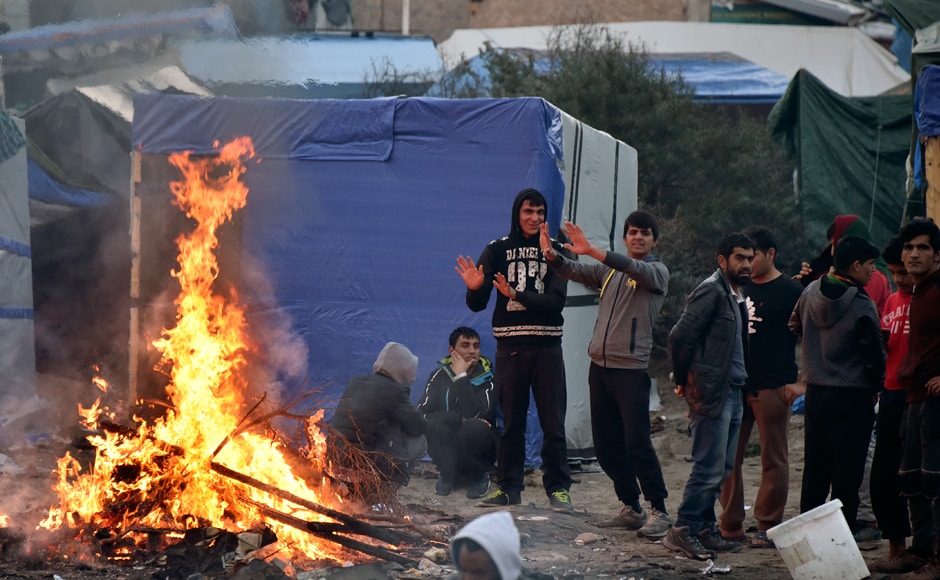 The French government has started clearing the "Jungle" migrant camp on France's norther coast. Migrants, primarily from Africa and Middle East, used to live there. They try to warm themselves while waiting to be relocated. Photo: AFP The French government has started clearing the "Jungle" migrant camp on France's norther coast. Migrants, primarily from Africa and Middle East, used to live there. They try to warm themselves while waiting to be relocated. Photo: AFP