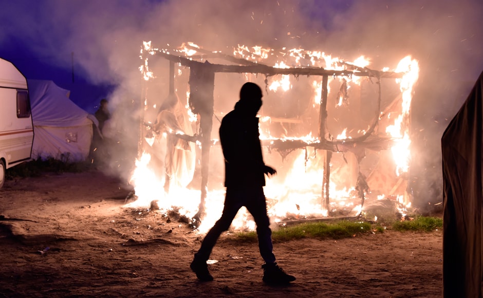 The "Jungle" is a collection of tents and shelters patched together. They were burnt down by the authorities during the clearing operation. A migrant walks past a shack set on fire during the demolition of the camp. Photo: AFP The "Jungle" is a collection of tents and shelters patched together. They were burnt down by the authorities during the clearing operation. A migrant walks past a shack set on fire during the demolition of the camp. Photo: AFP