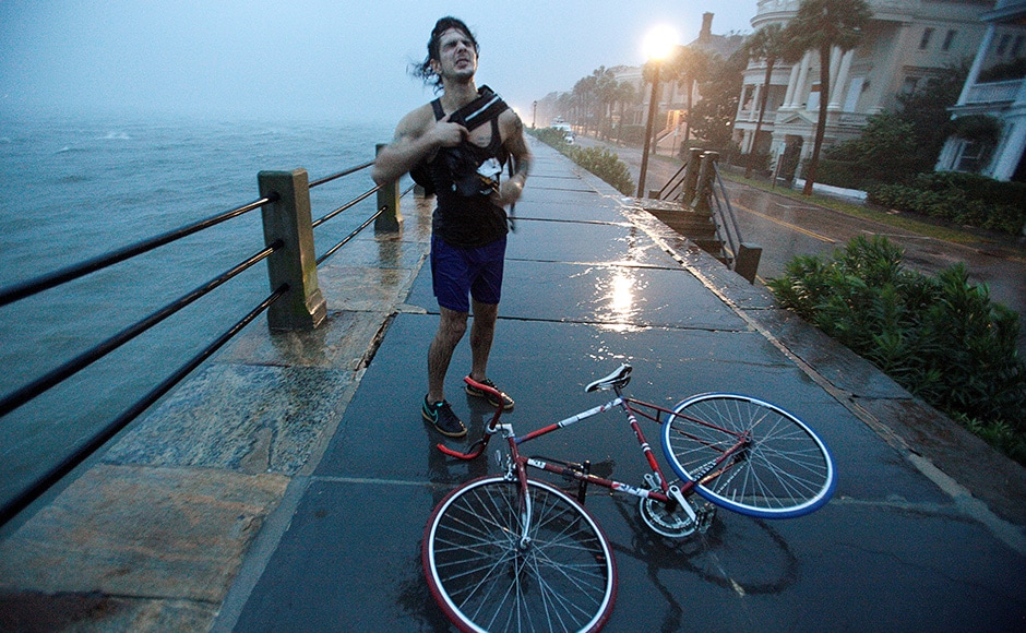 A Charleston resident reacts to the wind and rain as he pauses with his bicycle along the East Battery promenade on the southern tip of the city as Hurricane Matthew arrives in Charleston, South Carolina. Matthew triggered mass evacuations along the US Atlantic coast from Florida northward through Georgia and into South Carolina and North Carolina. Reuters A Charleston resident reacts to the wind and rain as he pauses with his bicycle along the East Battery promenade on the southern tip of the city as Hurricane Matthew arrives in Charleston, South Carolina. Matthew triggered mass evacuations along the US Atlantic coast from Florida northward through Georgia and into South Carolina and North Carolina. Reuters