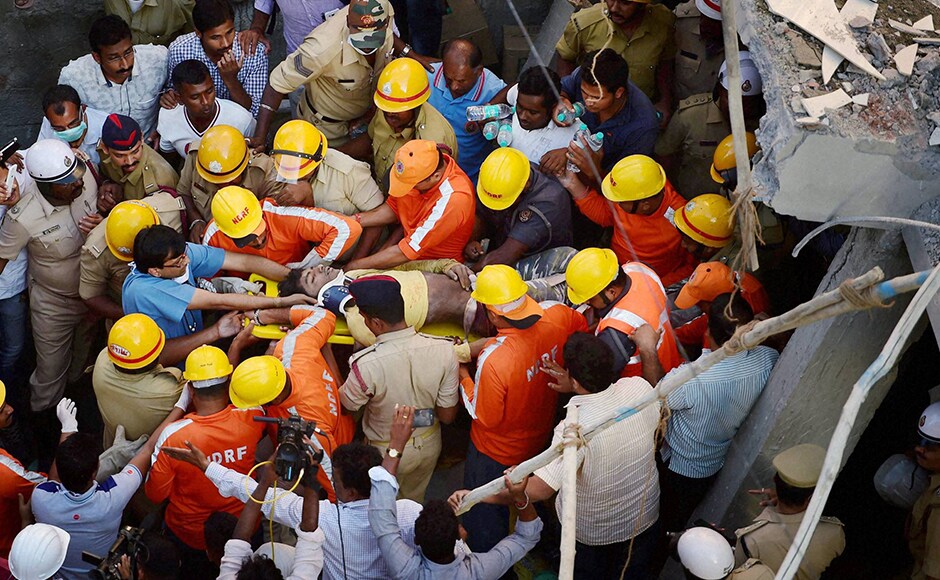 Four persons escaped while one person was rescued alive. NDRF personnel carried the injured person to an ambulance after he was rescued. Photo: PTI Four persons escaped while one person was rescued alive. NDRF personnel carried the injured person to an ambulance after he was rescued. Photo: PTI