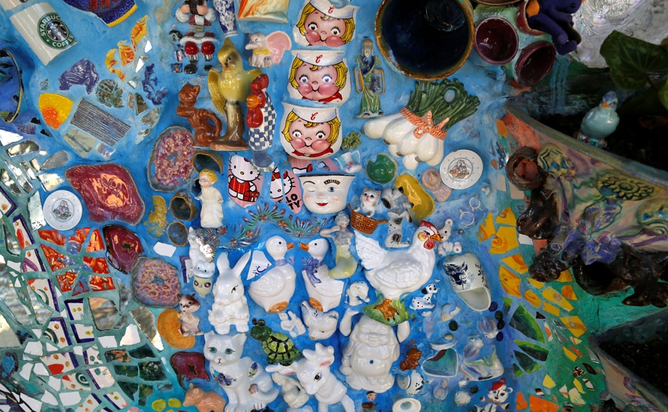Coffee mugs and other objects are pictured cemented into a wall at the Mosaic Tile House. Image from Reuters Coffee mugs and other objects are pictured cemented into a wall at the Mosaic Tile House. Image from Reuters